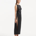 "Side view of the Apollo Black Dress, showcasing the asymmetrical cut and provocative side slit that adds a modern edge."