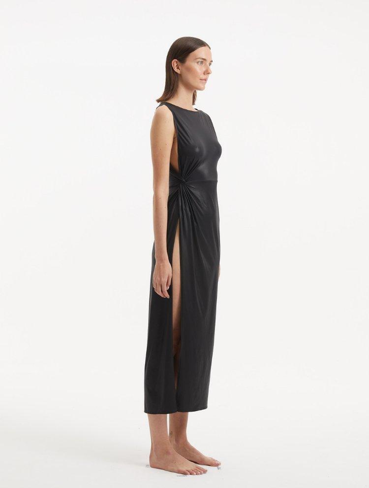 "Side view of the Apollo Black Dress, showcasing the asymmetrical cut and provocative side slit that adds a modern edge."