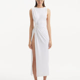 "Model showcasing the Apollo White Dress from the front, highlighting the elegant boat neckline, twist knot detail at the waist, and luxurious satin fabric."
