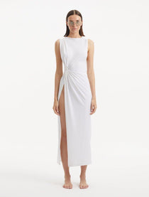 "Model showcasing the Apollo White Dress from the front, highlighting the elegant boat neckline, twist knot detail at the waist, and luxurious satin fabric."