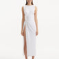 "Model showcasing the Apollo White Dress from the front, highlighting the elegant boat neckline, twist knot detail at the waist, and luxurious satin fabric."