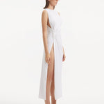 "Side view of the Apollo White Dress, emphasizing the asymmetrical hem and side slit that add a dynamic and daring touch."