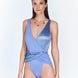  "Model wearing the Aria Swimsuit from the front, showcasing the V neckline, wrap-around front, and high-cut leg in a combination of matte and satin fabric."