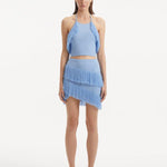 "Model showcasing the Arlo Baby Blue Skirt from the front, highlighting the hand-knitted texture, high-rise cut, and playful fringed details."