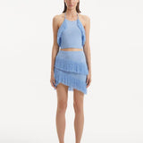 "Model showcasing the Arlo Baby Blue Skirt from the front, highlighting the hand-knitted texture, high-rise cut, and playful fringed details."