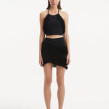 "Model showcasing the Arlo Black Skirt from the front, highlighting the hand-knitted design, high-rise cut, and playful fringed details."