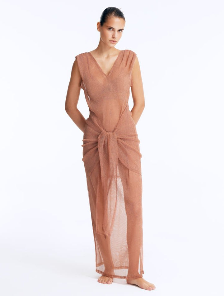 Front View: Model in Aster Bronze Dress - Maxi Dress, Sleeveless, V-Neckline, Sheer Soft Fabric, Tie Front Detail, MOEVA Luxury Beachwear