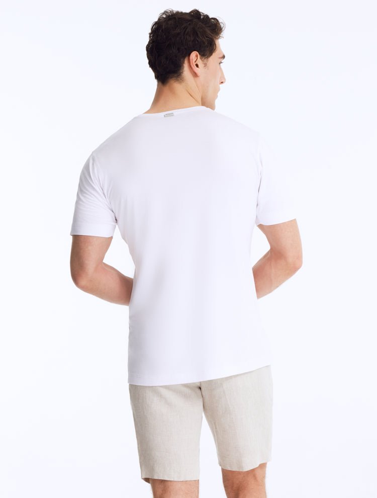 Back View: Model Showing Atlas White T-Shirt - Men's Slim Fit Tee, Embroidered Moeva Emblem, Short-Sleeve - MOEVA Luxury Swimwear