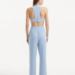"Back view of the Augustine White Baby Blue Top and Wade Pants, displaying the contemporary cropped silhouette and stylish design."