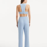 "Back view of the Augustine White Baby Blue Top and Wade Pants, displaying the contemporary cropped silhouette and stylish design."