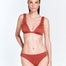 "Red Ochre Aya Bikini Bottom on a model from the front, showcasing the low rise hipster design and medium coverage."