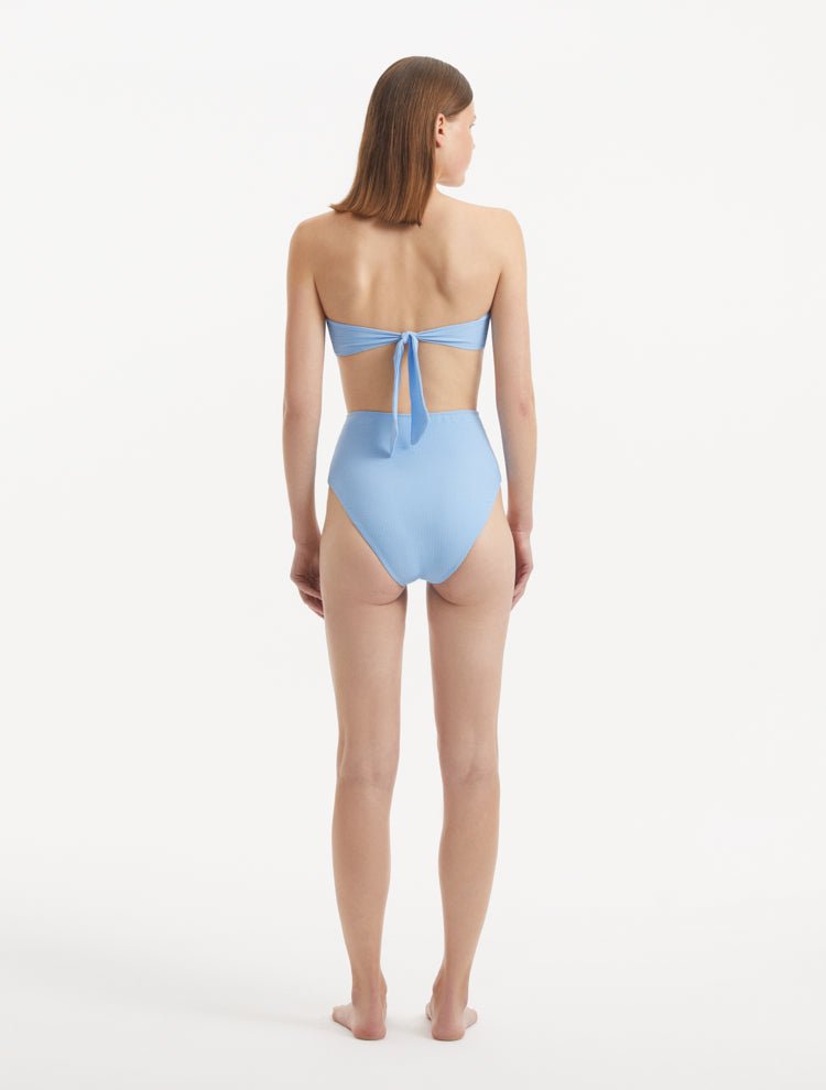 Baia Baby Blue Bikini Top back view, featuring elegant golden clasps and secure fit.