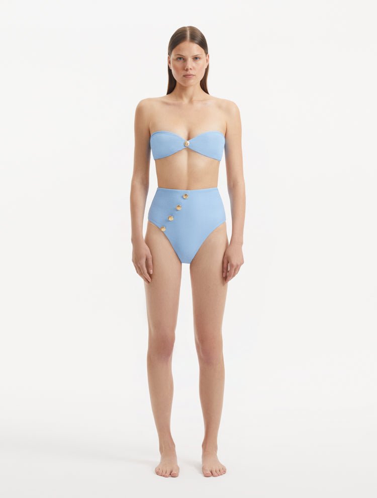 Baia Baby Blue Bikini Top front view, highlighting strapless bandeau design and gold shell accents.