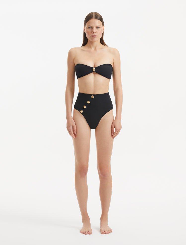 Baia Black Bikini Bottom front view, showcasing high-waist design and gold shell buttons.