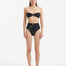 Baia Black Bikini Bottom front view, showcasing high-waist design and gold shell buttons.