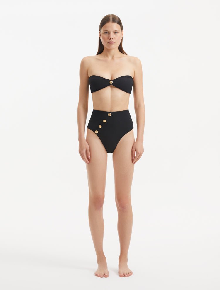 Baia Black Bikini Top front view, highlighting bandeau design and gold button detailing.