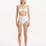 Front view of Baia White Bikini Bottom, showcasing high-waist design and gold button accents.