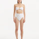 Front view of Baia White Bikini Top, showcasing bandeau design and shell-shaped gold buttons.