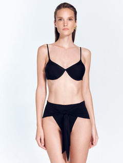 Front View: Model in Beatrice Black Bikini Top - MOEVA Luxury Swimwear, Underwired Top, Satin Matte Contrast, Adjustable Straps, MOEVA Luxury Swimwear