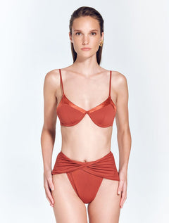 Front View: Model in Beatrice Red Ochre Bikini Top - MOEVA Luxury Swimwear, Underwired Top, Satin Matte Contrast, Adjustable Straps, MOEVA Luxury Swimwear