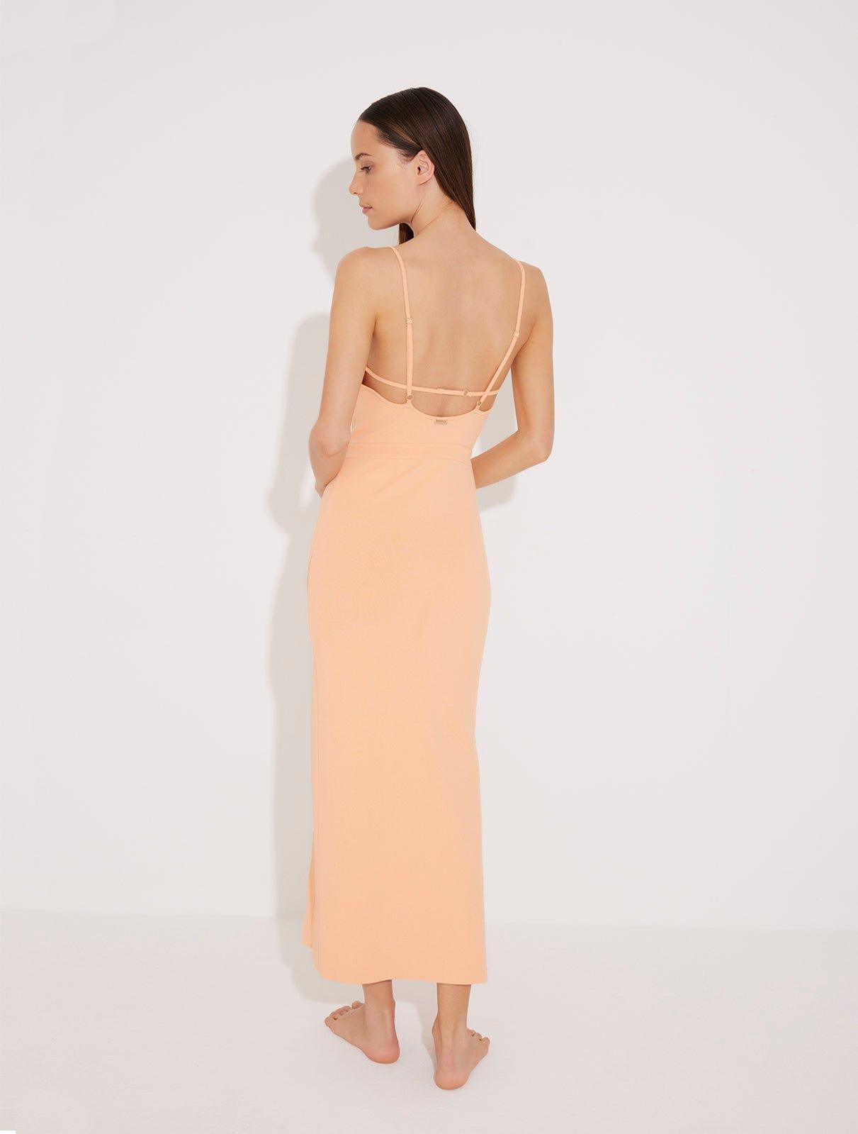 "Back view of the Beau orange sleeveless knitted dress displaying the low back and adjustable straps with metal trims for a perfect fit and added elegance."