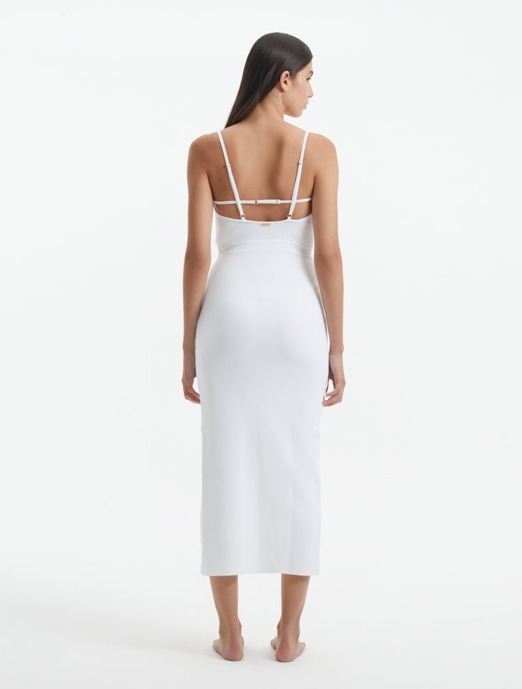 Back View: Model in Beau White Dress - MOEVA Luxury Swimwear, Low Back, Adjustable Straps with Metal Trims, Side Slit, Ready to Wear Maxi Dress, MOEVA Luxury Swimwear