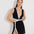 Front View: Model in Blanca Black/White Dress - MOEVA Luxury Swimwear, Mini Dress, Gold Button Detail Throughout, Detachable Top and Skirt, Hidden Zipper At The Side, Front Slit,  MOEVA Luxury Swimwear