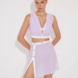 "Model wearing Blanca Lilac/White Asymmetrical Dress with gold button accents."