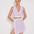 Front View: Model in Blanca Lilac/White Dress - MOEVA Luxury Swimwear, Mini Dress, Gold Button Detail Throughout, Detachable Top and Skirt, Hidden Zipper At The Side, Front Slit,  MOEVA Luxury Swimwear