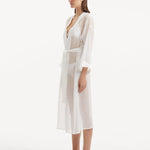 "Side view of the Blaze white kaftan, featuring its transparent fabric and wavy details that bring a touch of feminine whimsy to the overall design."