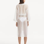 Back view of the Blaze white kaftan, highlighting the graceful ankle-length flow and the self-tie belt that adds emphasis to the waistline for a stunning silhouette."