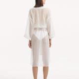 Back view of the Blaze white kaftan, highlighting the graceful ankle-length flow and the self-tie belt that adds emphasis to the waistline for a stunning silhouette."