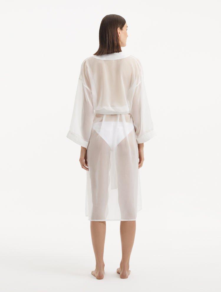 Back view of the Blaze white kaftan, highlighting the graceful ankle-length flow and the self-tie belt that adds emphasis to the waistline for a stunning silhouette."