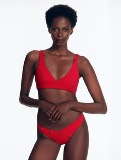 "Front view of the Brenda Bikini Bottom with chic V-cut and button details on a model."