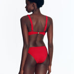 "Back view of the Brenda Bikini Top with chic design and button accents on a model."