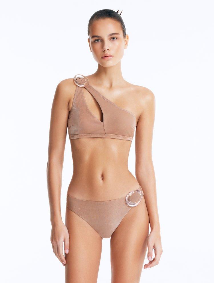 Front View: Model in Calix Bronze Bikini Set - One Shoulder, Fully Lined, Chic, Metallic Fabric, Clear Glass Hoop Accessory Detail, MOEVA Luxury Swimwear
