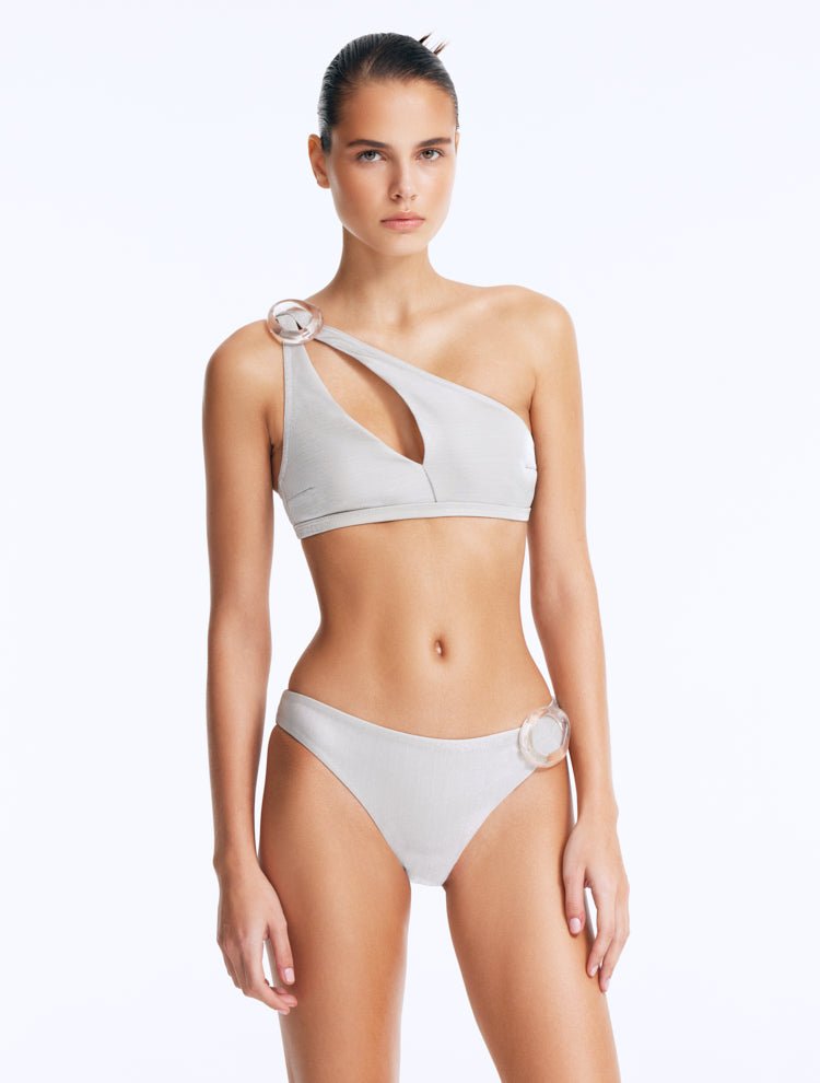 Front View: Model Wearing Calix Silver Bikini Bottom - Metallic Fabric, Chic and Accessorized, Clear Glass Hoop Accessory, MOEVA Luxury Swimwear