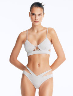 Front View: Model Wearing Cassia Silver Bikini Set- Low Waist Briefs, Chic and Accessorized, Metallic Fabric, MOEVA Luxury Swimwear