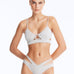 Front View: Model Wearing Cassia Silver Bikini Set- Low Waist Briefs, Chic and Accessorized, Metallic Fabric, MOEVA Luxury Swimwear