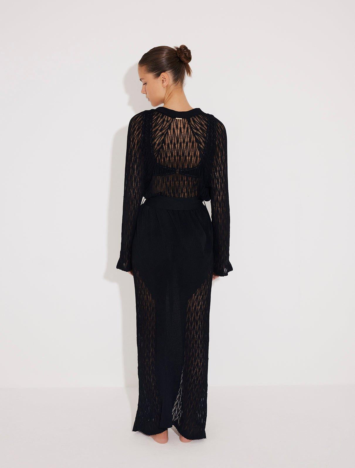 Back View: Model in Chad Black Kaftan - MOEVA Luxury Swimwear, Knitted Ankle Length Beach Kaftan, Self-Tie Belt, Loose Fit, MOEVA Luxury Swimwear