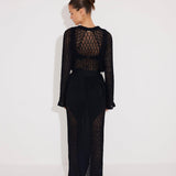 Back View: Model in Chad Black Kaftan - MOEVA Luxury Swimwear, Knitted Ankle Length Beach Kaftan, Self-Tie Belt, Loose Fit, MOEVA Luxury Swimwear