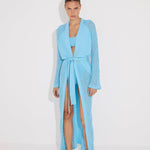 "Front view of a model in the Chad Blue Kaftan, displaying the layered neckline and mesh panels."