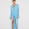 "Front view of a model in the Chad Blue Kaftan, displaying the layered neckline and mesh panels."