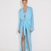 "Front view of a model in the Chad Blue Kaftan, displaying the layered neckline and mesh panels."