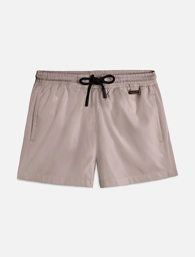 "Front view of the Charlie Khaki Kids Swim Shorts, showcasing the elastic waistband with adjustable drawstring and the Moeva patch."