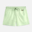 "Front view of the Charlie Mint Green Kids Swim Shorts from the front, focusing on the elastic waistband and Moeva patch."