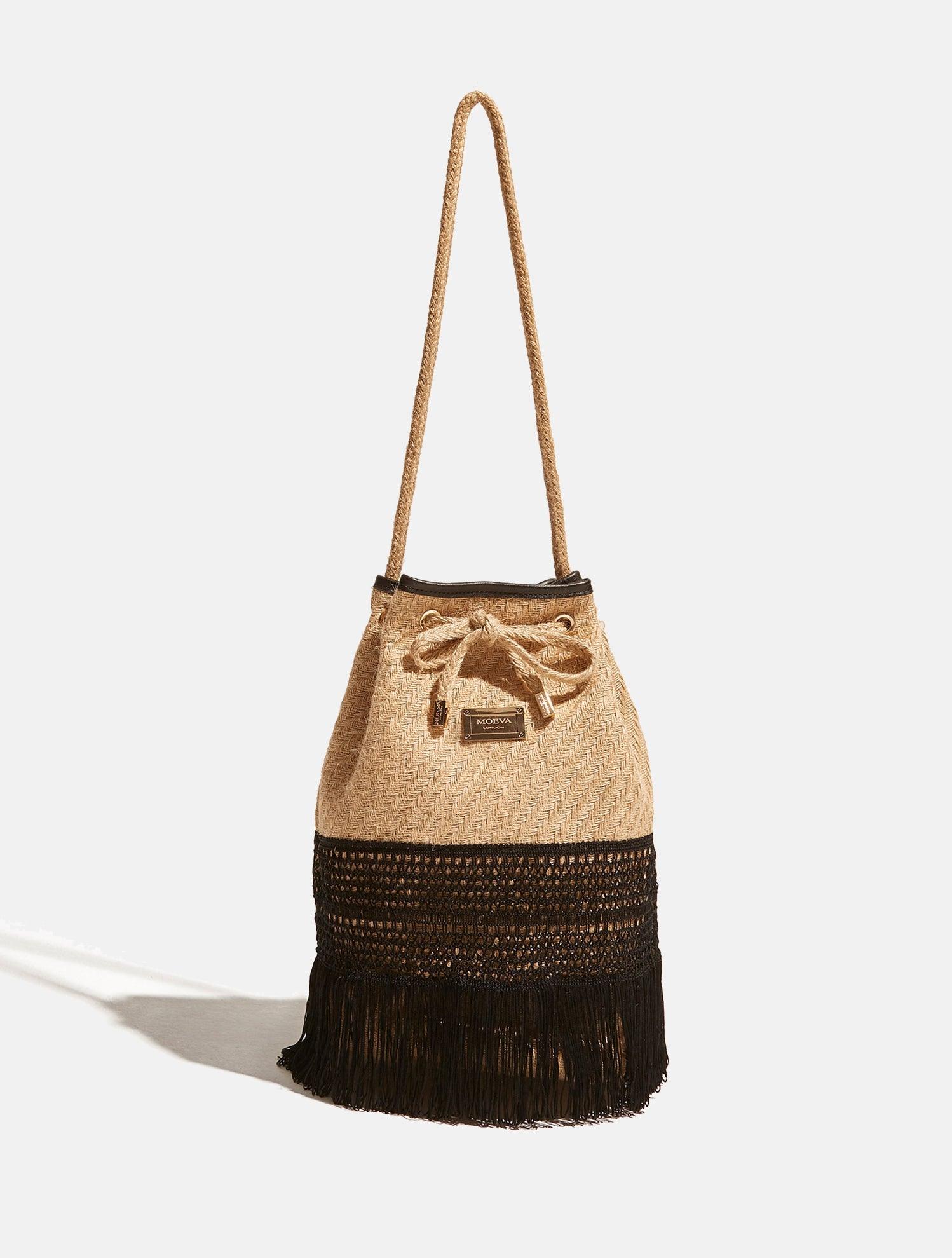 "Chelsea Black Bag with embroidered and fringed details, bucket straw design, gold-dipped Moeva logo bar, and leather lining."