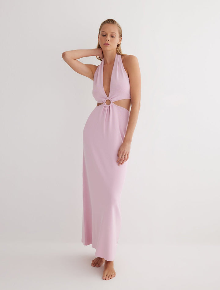 Front View: Model in Clemence Pink Dress - MOEVA Luxury Swimwear, Knitted Dress, Halterneck, Side Cutouts, Ring Connecting Top to the Skirt, Ankle Length, Close Fit, MOEVA Luxury Swimwear