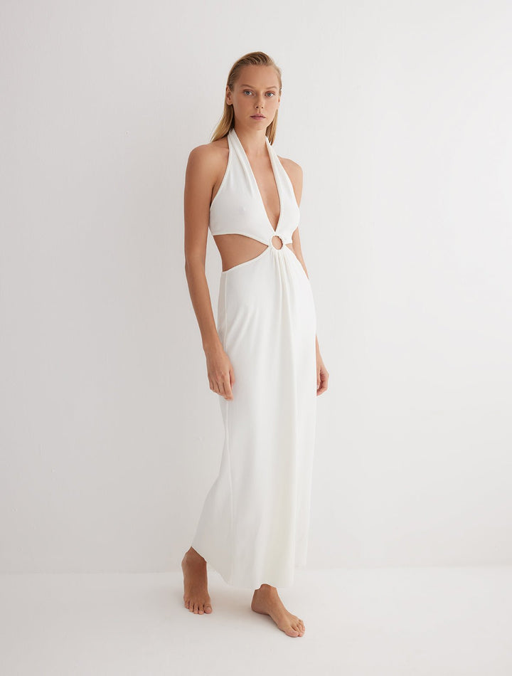 Front View: Model in Clemence White Dress - MOEVA Luxury Swimwear, Knitted Dress, Halterneck, Side Cutouts, Ring Connecting Top to the Skirt, Ankle Length, Close Fit, MOEVA Luxury Swimwear