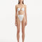 Front view of the Clyde White Bikini Bottom highlighting the high-waist design and gold sculpted accessories.